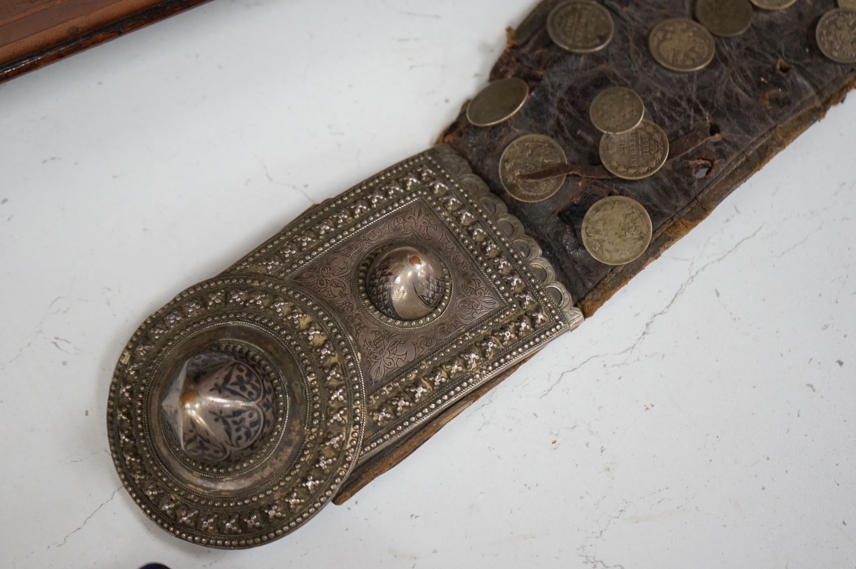 A 19th century Persian silver, niello work and coin mounted belt, dated 1880 (1297 AH in script) and an African sword (broken)
